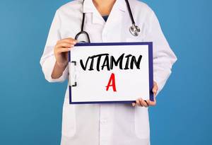 Doctor holding clipboard with Vitamin A text