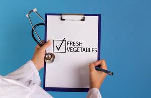 Doctor with prescription start eating fresh vegetables