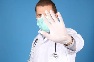 Doctor with stethoscope showing stop gesture