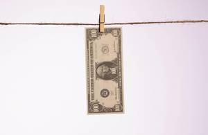 Dollar banknote hanging on a clothes line