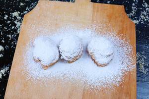 Doughnuts with powdered sugar on wooden background (Flip 2019)