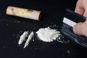 Drug addict makes cocaine lines with a credit card