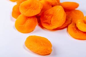 Dry apricots fruit on white background close up