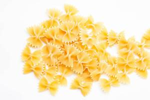 Dry farfalle pasta on white background  Flip 2019