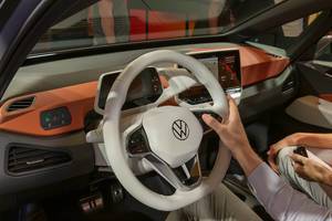 E-Mobility by Volkswagen: black-orange interior Design of VW electric vehicle ID.3, with digital instrument panel & Touch display