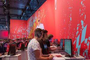 EA gaming station: Video players playing the soccer game FIFA 20 at Gamescom