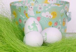 Easter eggs on green grass with basket