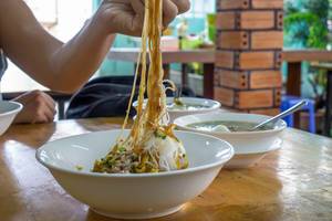 Eating Vietnamese Noodles with Pork in a Breakfast Restaurant in Saigon  Flip 2019