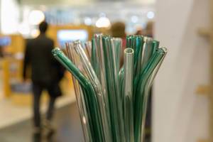 Eco-friendly glassy straws for reduction of plastic, background with blur