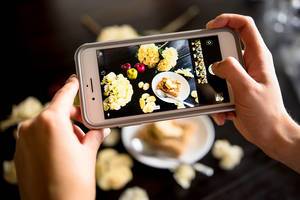 Ein Foto von einer Mahlzeit wird mit einem Iphone aufgenommen