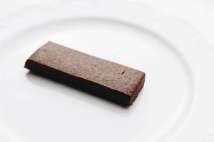 Eiweißriegel mit Schokoladengeschmack vor weißem Hintergrund