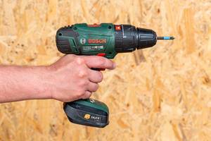 Electric drill holding a man in his hand