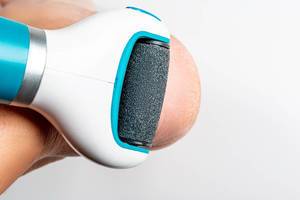 Electric roller file for removing coarse skin of the heel on white background