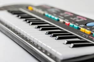 Electronic piano keyboard with black and white.
