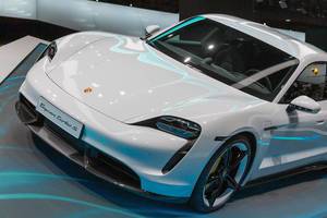 Elektric-sports car by Porsche: close-up of white Taycan Turbo S
