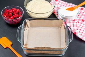 Empty baking tray and ingredients for making berry pie