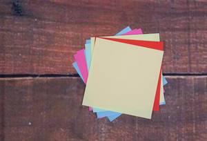 Empty colorful sticky notes on wooden background