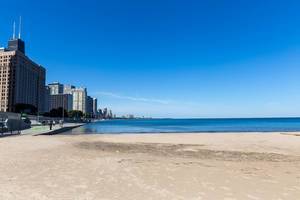 Empty Ohio Street Beach on the shores of Lake Michigan in Chicago on a sunny autumn day with blue sky