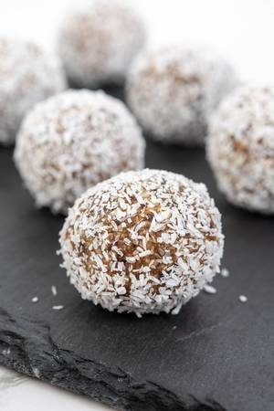 Energy Balls with Almonds and Walnuts with Coconut on the plate