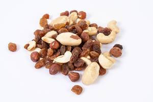 Energy mix with raisins hazelnuts cashew and brazilian nuts above white background (Flip 2019)