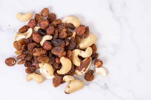 Energy mix with raisins hazelnuts cashew and brazilian nuts on the marble table (Flip 2019)