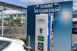 Environmental friendly gas station alternative: Tesla charges sun energy using type 2 plug, on an Aldi-Supermarket parking spot