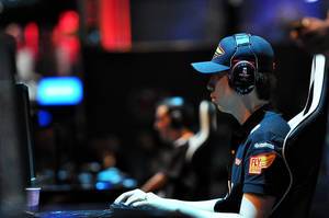 ESL Extreme Masters: profile view of a focused pro gamer with a headset and gaming equipment