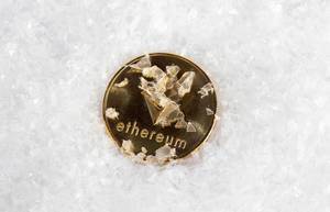 Ethereum coin covered with snow