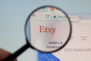 Etsy logo on a computer screen with a magnifying glass