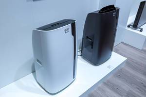 Exhibition of portable air conditioners "PAC EX100 Silent Pinguino" by DeLonghi, in black and white