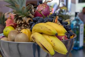 Exotic fruit basket with bananas, kiwi and pineapple