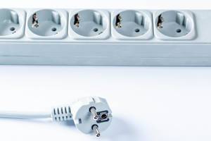 Extension cord with sockets on white background