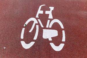 Fahrradsymbol in weiß auf rotem Fahrradweg