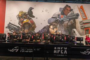 Fair visitors behind monitors at the game station of the free-to-play battle royale shooter Apex Legends by EA at Gamescom in Cologne