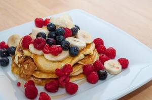 Favorite food for kids: Pancakes with sweet honey, healthy berries and bananas