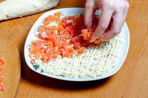 Female hand adds sliced salmon to salad (Flip 2020)