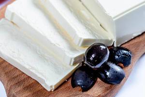 Feta cheese with olives on wooden board  Flip 2019