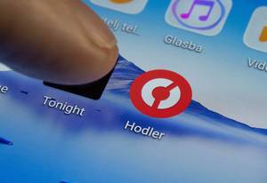 Finger drückt auf Touchscreen Symbol von Hodler App auf Smartphone oder Tablet