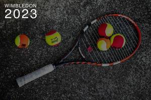 Five coloured tennis balls and a tennis racket on stone, next to the text "Wimbledon 2023"