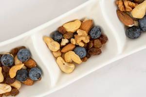 Flat lay above Crispbreads Blueberries Almonds Raisins and other in the bowl