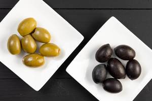 Flat lay above Green and Black Olives on the plate
