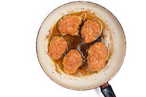 Flat lay above metal pan with frying meatballs in oil