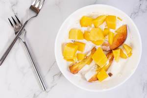 Flat lay above Peaches and Mango in the Greek Yogurt