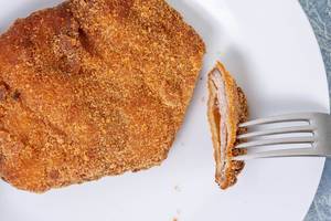 Flat lay above served Breaded Meat on the plate (Flip 2019)