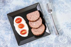 Flat lay above Served Pork and Chicken Meat Loaf with Tomatoes (Flip 2019)