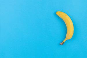 Flat lay Banana on the Blue background with copy space