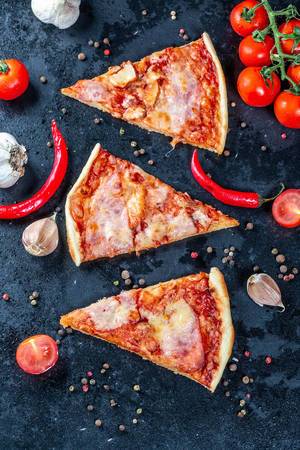 Flat lay composition slices of pizza with bacon, cheese and tomato sauce