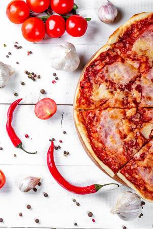 Flat lay composition with pizza and ingredients on wooden background