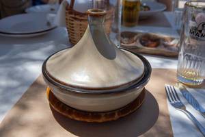 Food bowl with a ceramic heat containing lid in a greek Restaurant