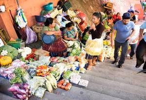 Food market entrance in Guatemala - Natives selling vegetables on stairs